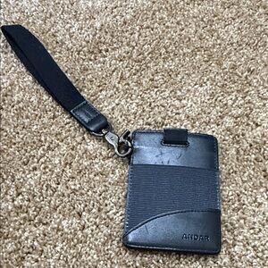 Black Leather credit card wallet. you have a tab that cards come out